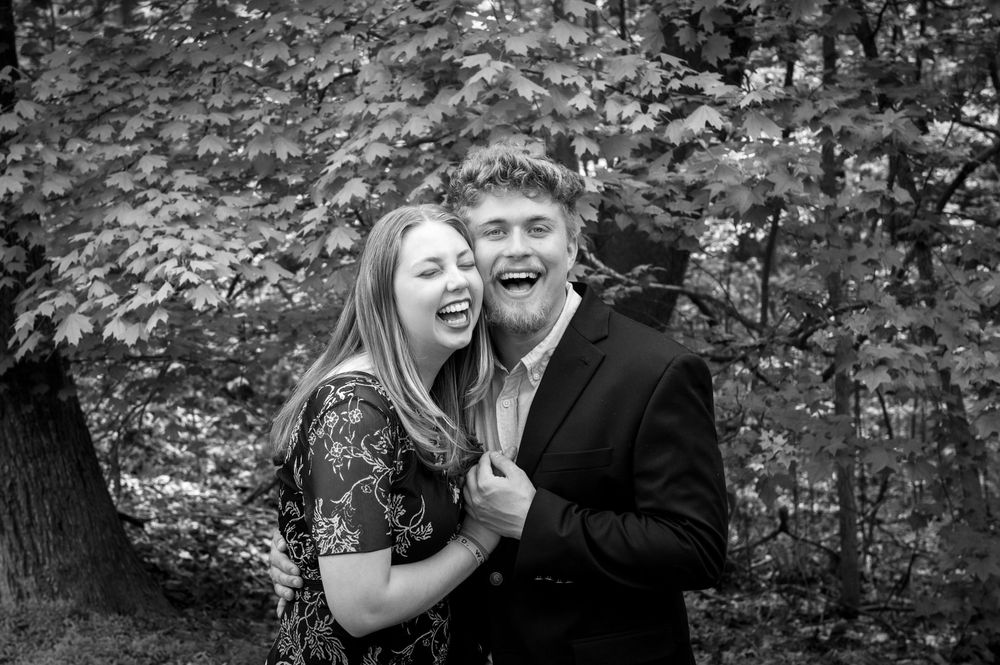 Black and white romantic portrait series in a wooded outdoor setting.