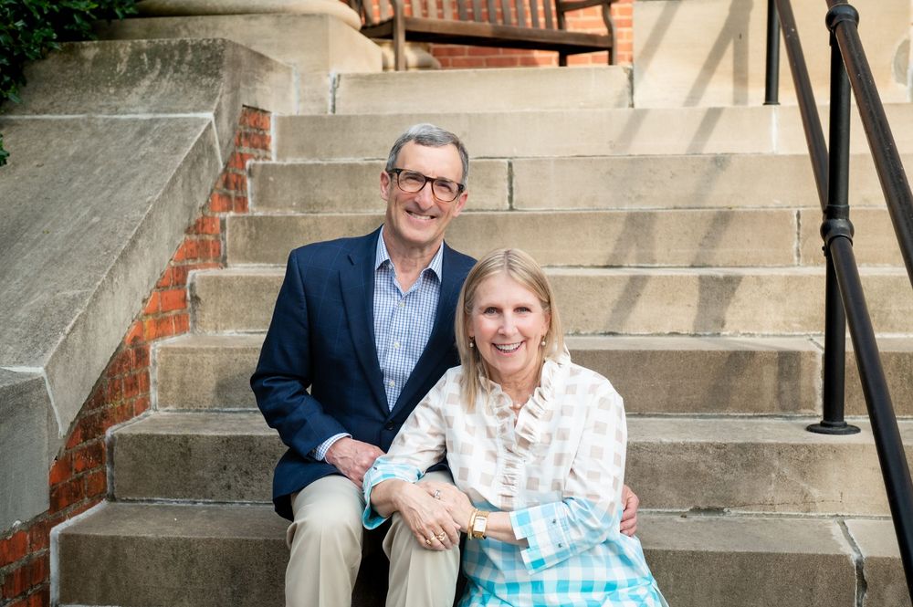 Sweet couple portrait session on rustic brick steps in natural lighting.
