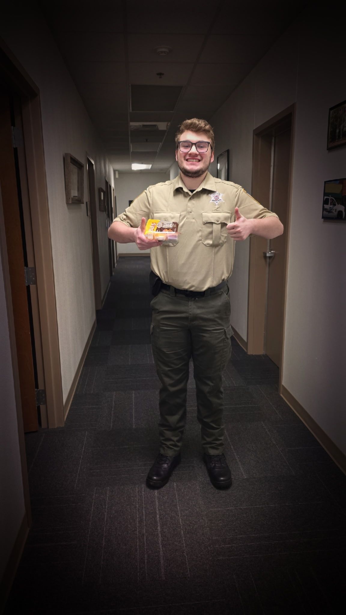 Person in uniform jumping in a dimly lit hallway.