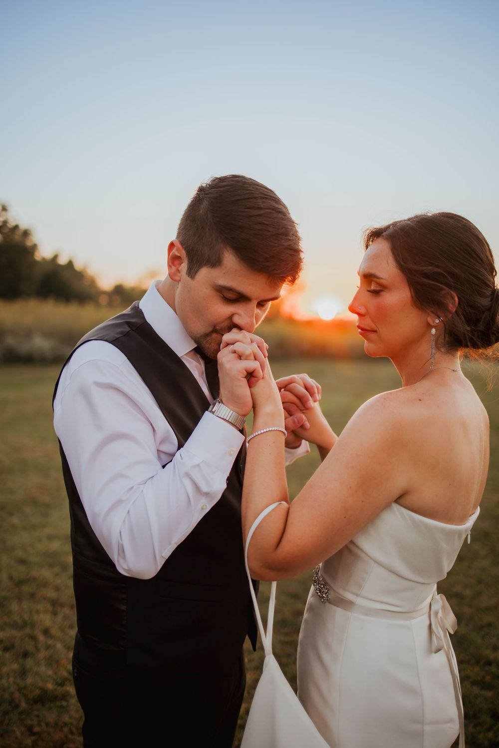 Bride and groom just married, kissing hand at Sunset in Zionsville, Indiana