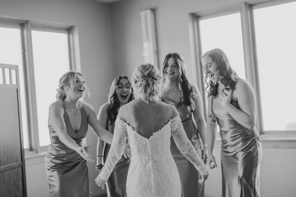 Bridesmaids emotional reaction to seeing Bride in her wedding dress in Zionsville, Indiana