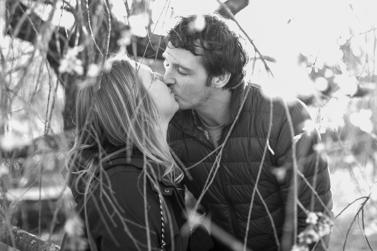 Couple kissing outdoors in Cincinnati capturing elegant, high-end romantic portraits for luxury clients