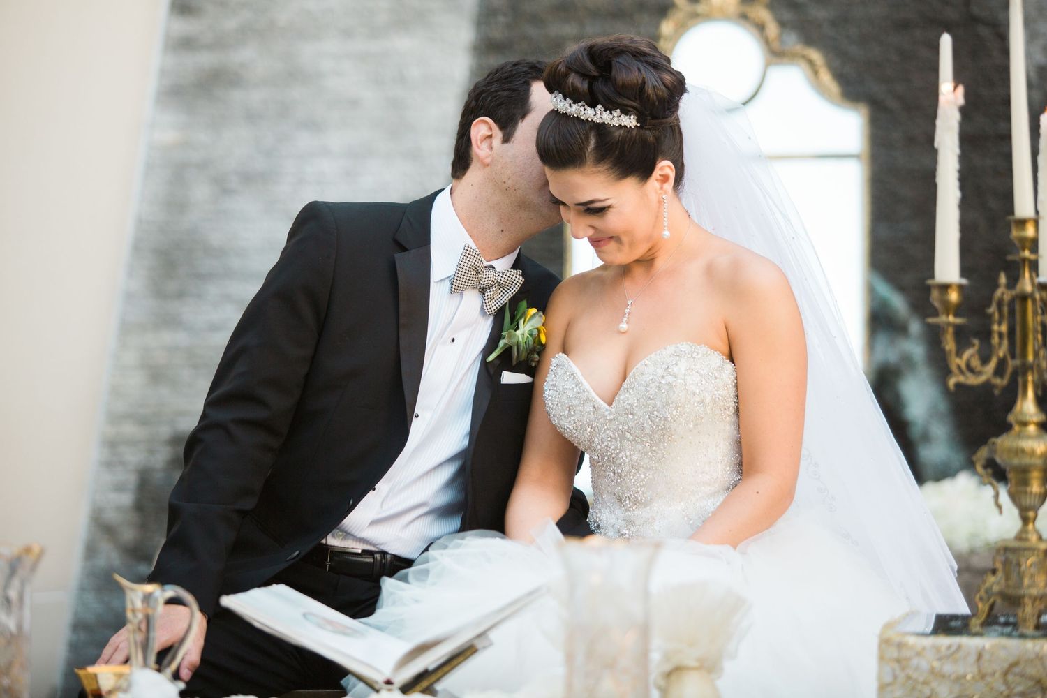 Close-up view of a vibrant red rose adorning an elegant updo hairstyle.