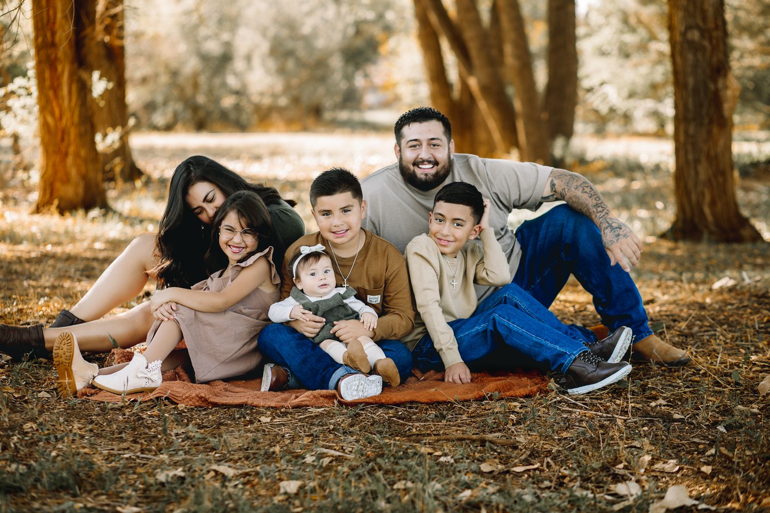 professional family pictures is more than just a photo session. a family of 6 with a baby posing for in colorado for pictures. greeley CO