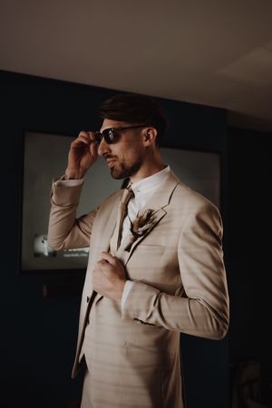 Groom portrait on his own capturing a natural moment during the wedding day
