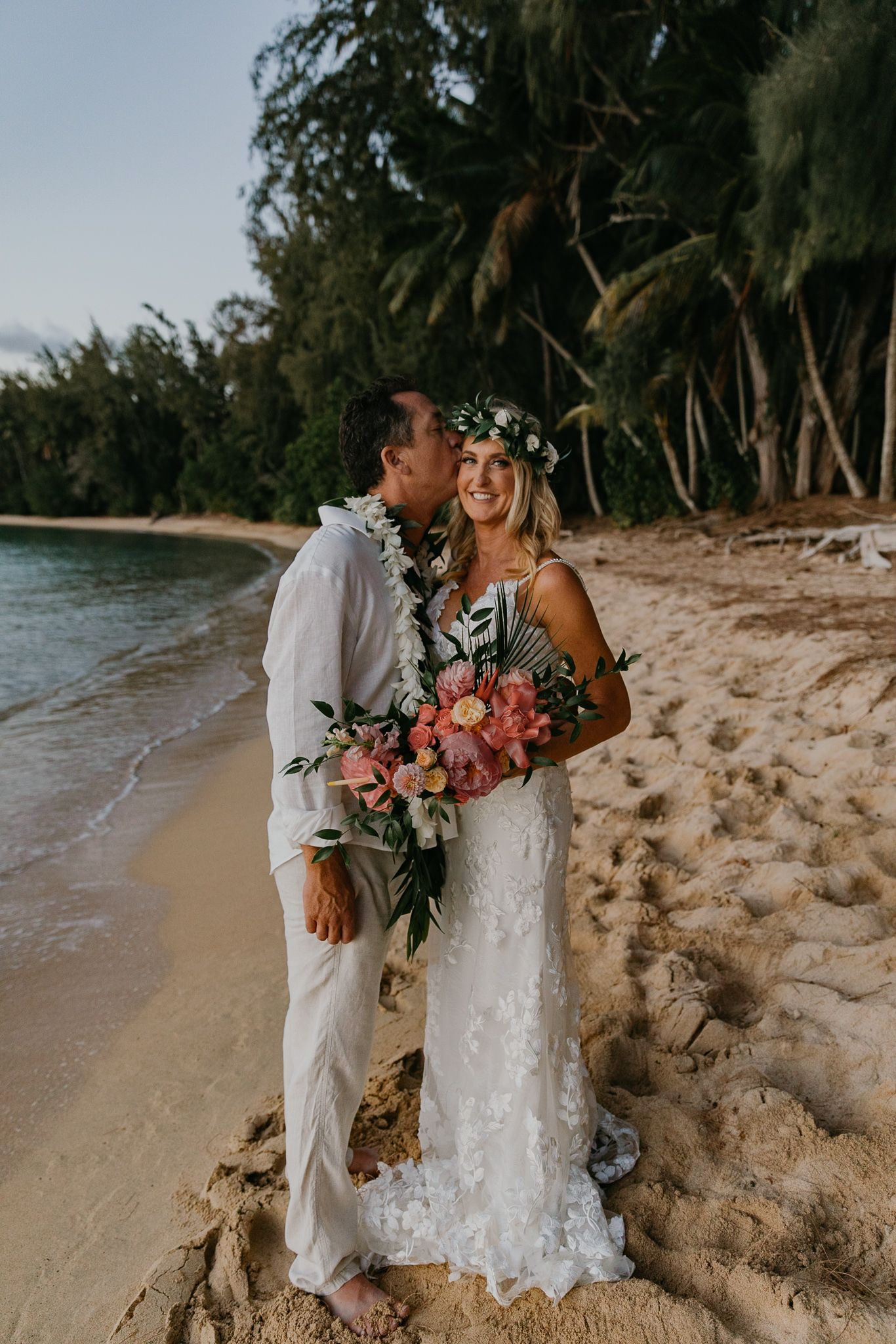 Orlando luxury wedding photographer bride and groom under the palm trees of a beach.
