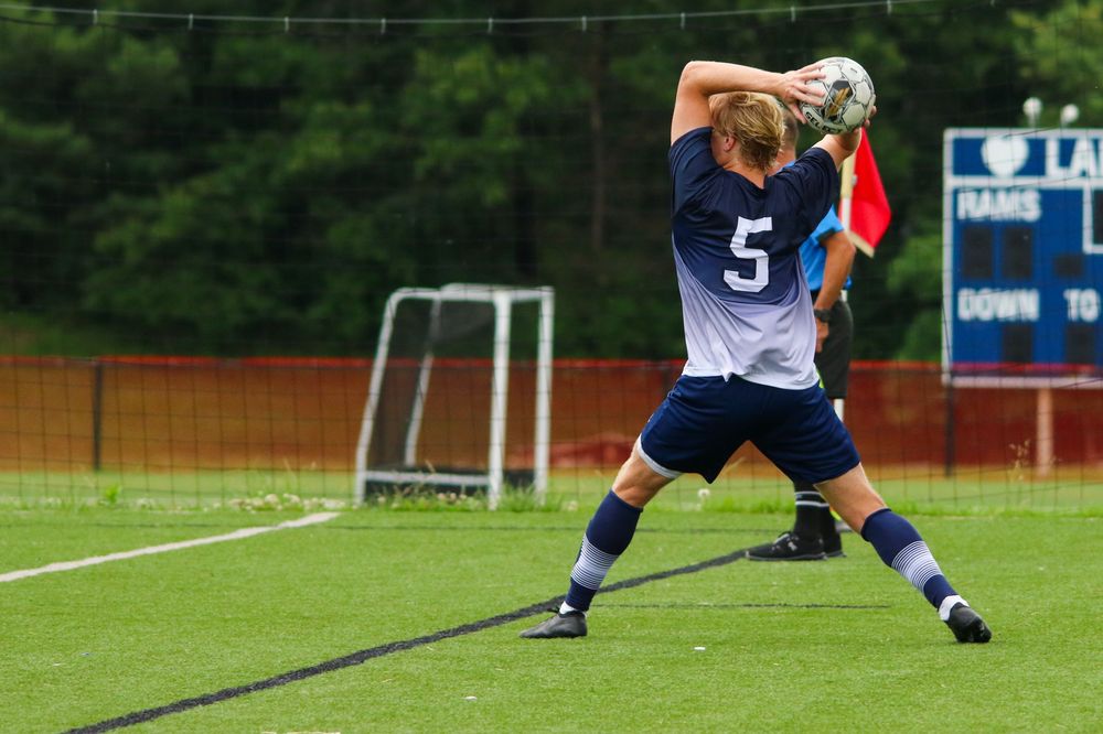 Soccer player throwing the ball in