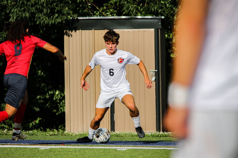 Soccer player dribbling around opponent