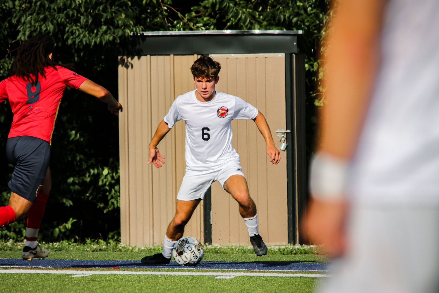 Soccer player dribbling around opponent