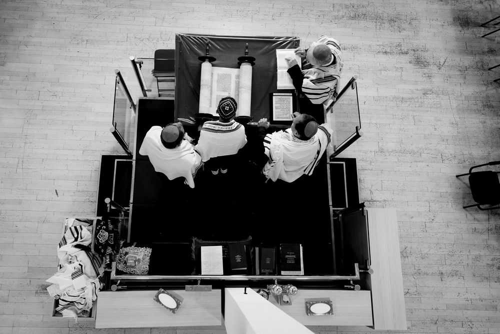 Bar Mitzvah boy reads the torah on the bimah in synagogue - ariel shot from above - Bar Mitzvah Photography