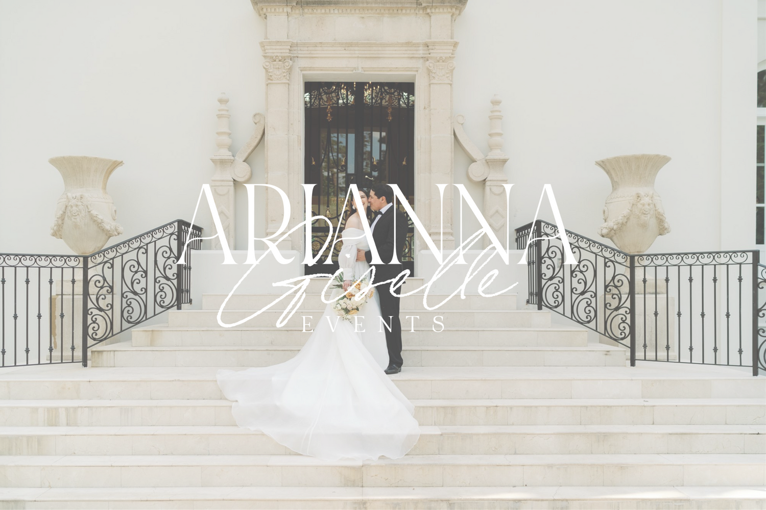 Elegant white stone staircase with decorative urns and formal architecture.