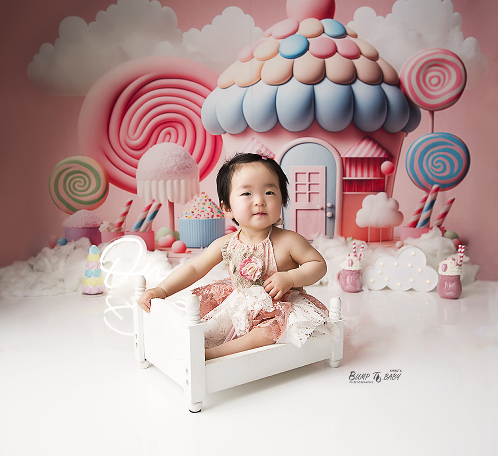 First birthday cake smash photography session with candy land theme in Croydon Melbourne, featuring colourful decorations, balloons, sweet t