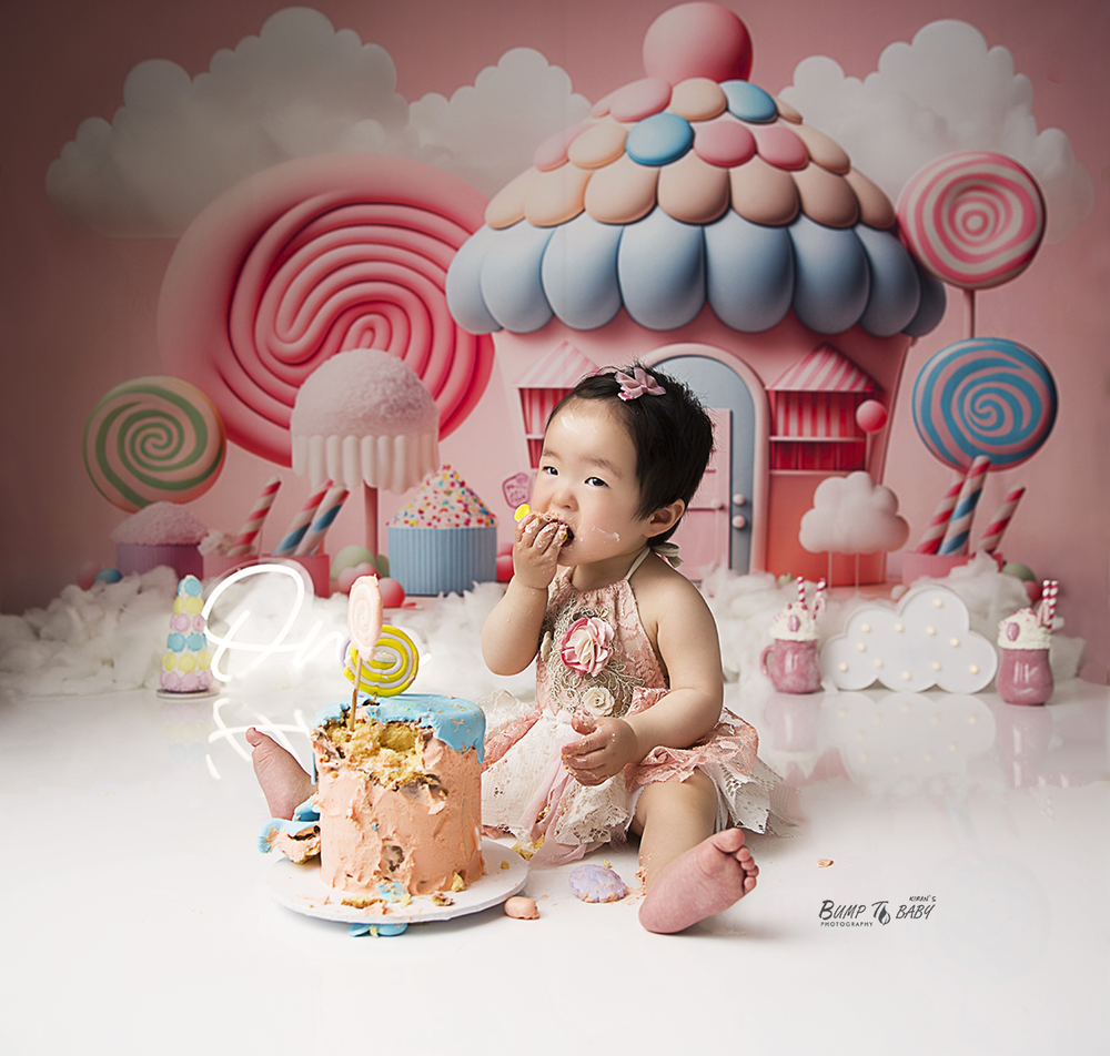 Baby girl candy theme cake smash photoshoot in Melbourne East studio with pastel colours, birthday cake, lollipops and adorable first birthd