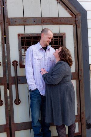 A romantic sequence showing a couple embracing against an industrial-style wall.