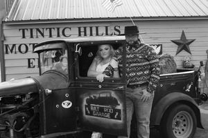 Exterior view of Tintic Hills building with vintage cars and western decor.