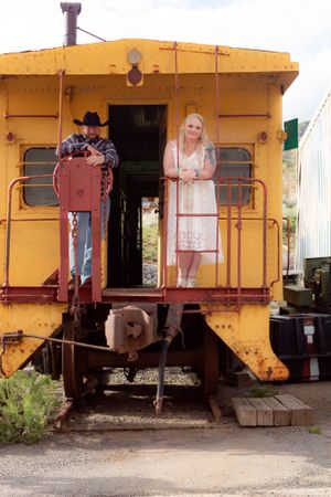Vintage yellow train cabooses lined up in a row showing weathered exteriors and rustic charm.