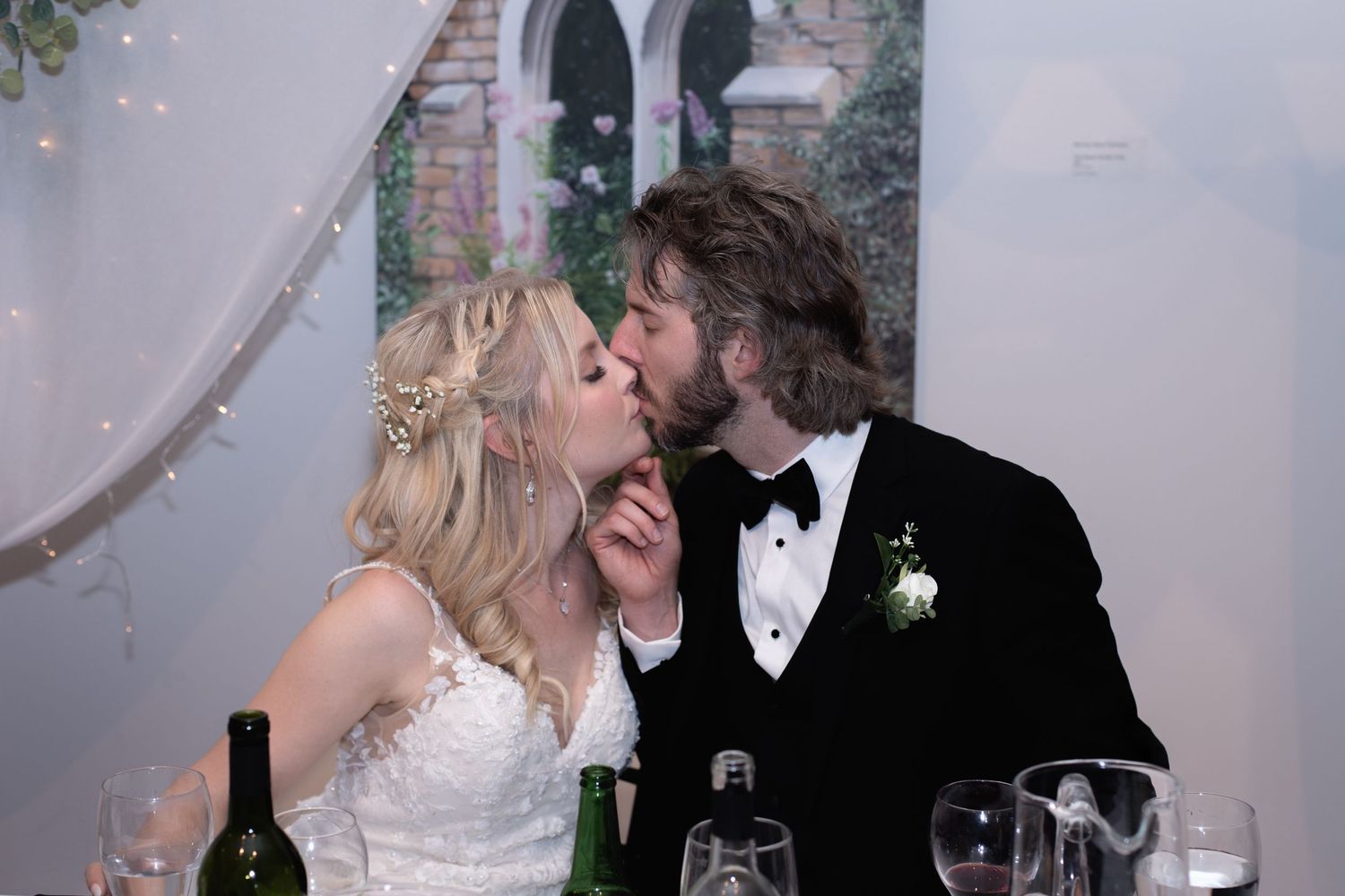 Romantic wedding portrait of a couple dancing on a wooden deck with flowing white dress.