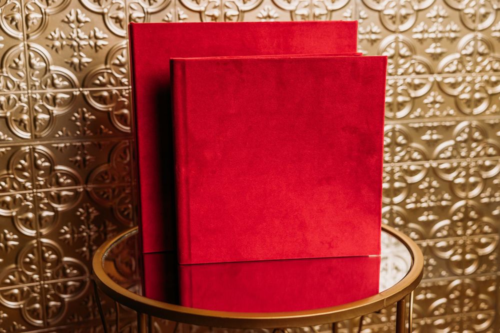 Luxury red velvet album in front of gold wall