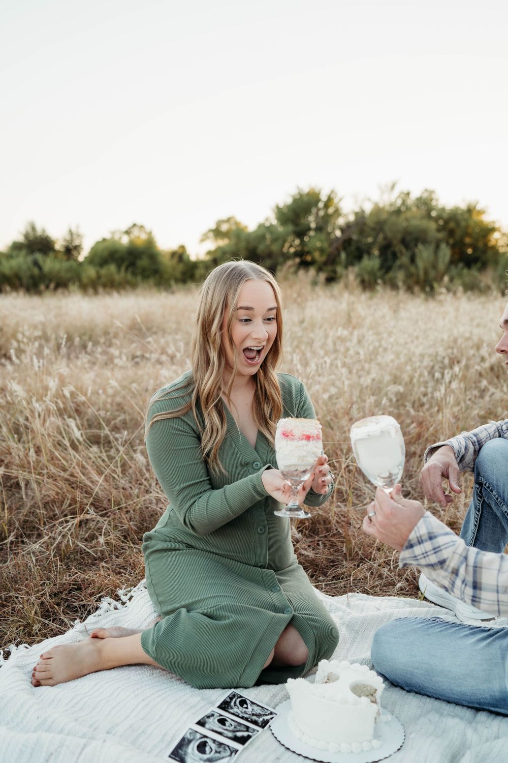 Woman in green dress celebrating gender reveal