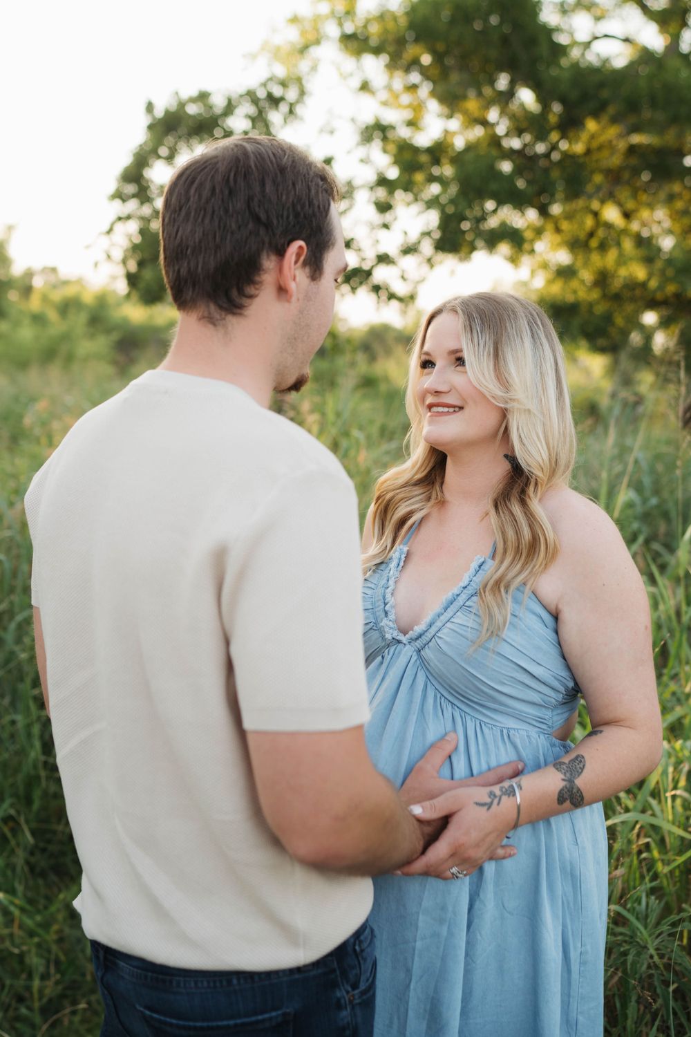 Expecting couple sharing intimate moment during outdoor maternity photo session in Oklahoma City.