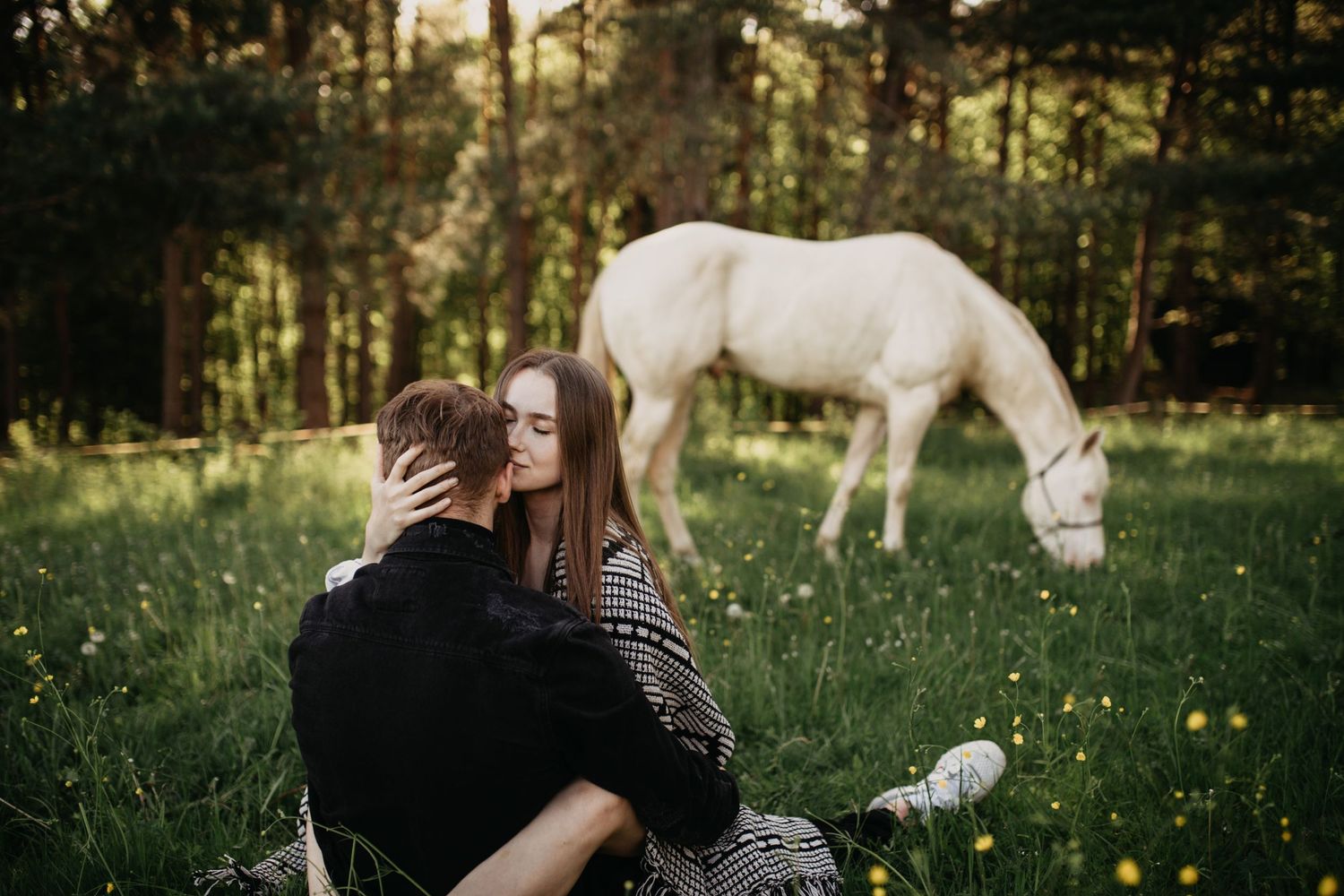 Párové romantické fotenie s bielym koňom v pozadí