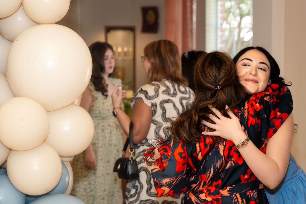 A festive party scene with white balloons decorating a bright interior space.