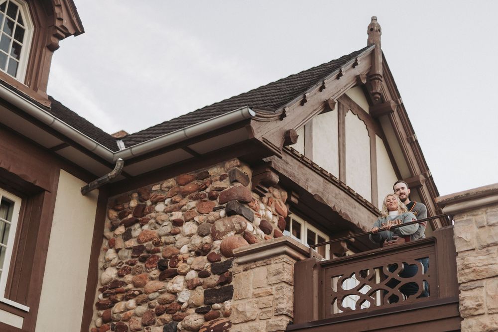 Architectural detail of a Tudor-style home exterior showing stone and wood gable with ornate trim details.