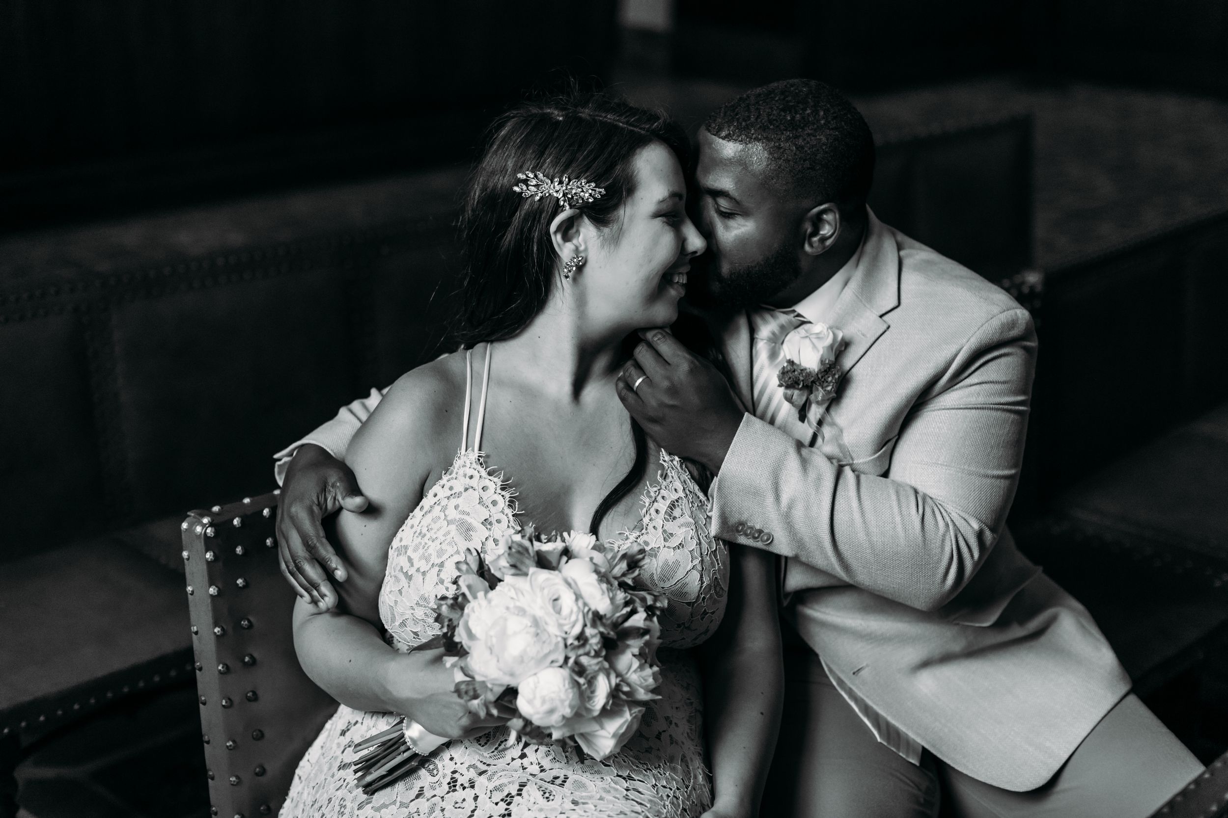 A romantic black and white wedding photo series showing intimate moments between a couple during their celebration.