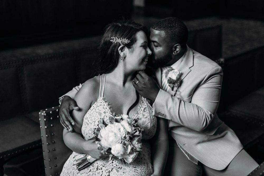 A romantic black and white wedding photo series showing intimate moments between a couple during their celebration.