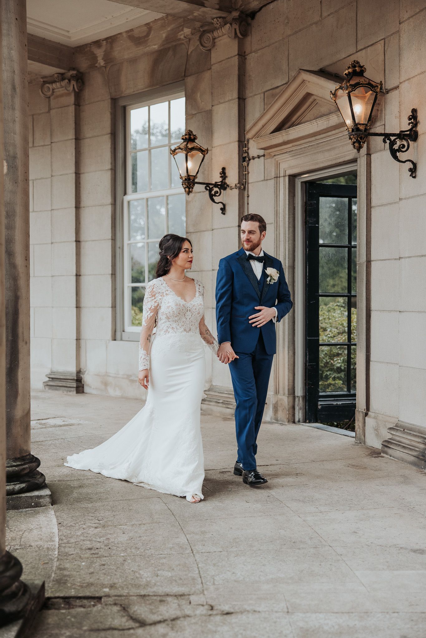Bride and groom holding hands walking into their wedding venue at Landgoed De Voorst.