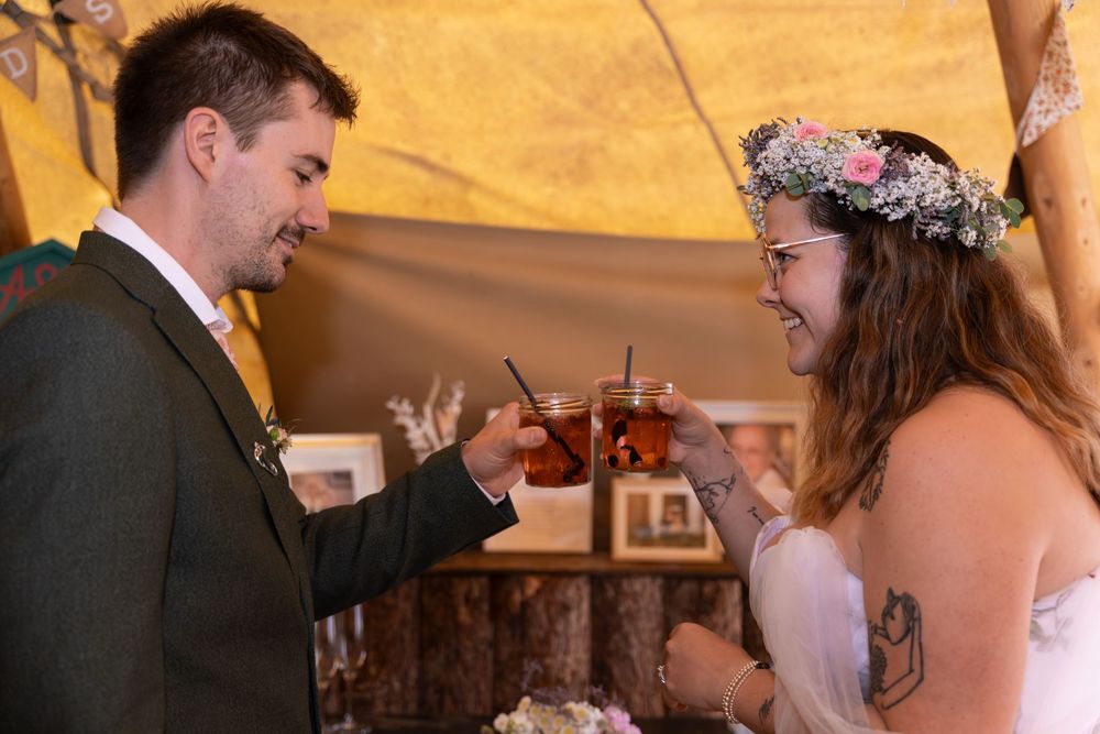 A happy couple shares a tender moment during their wedding reception as they feed each other cake.