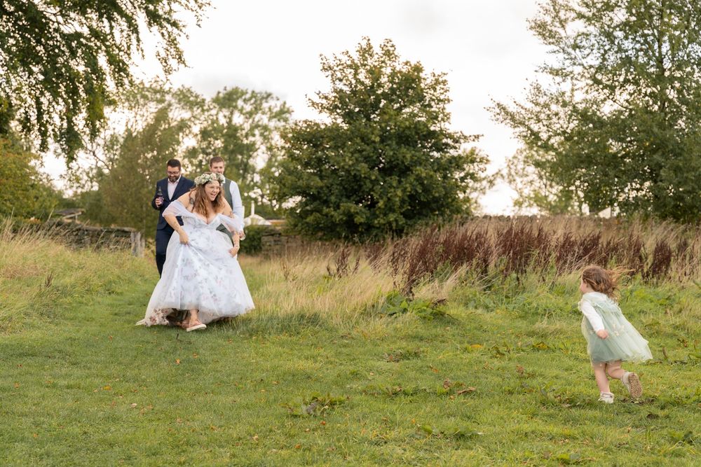 A sequence of photos showing a person in a white dress twirling and dancing in a sunny meadow with trees.