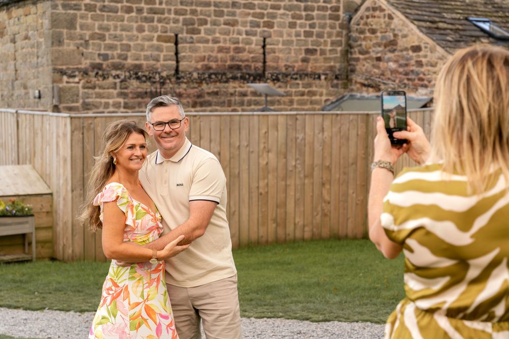 A couple shares tender moments in their backyard during a summer photoshoot session.