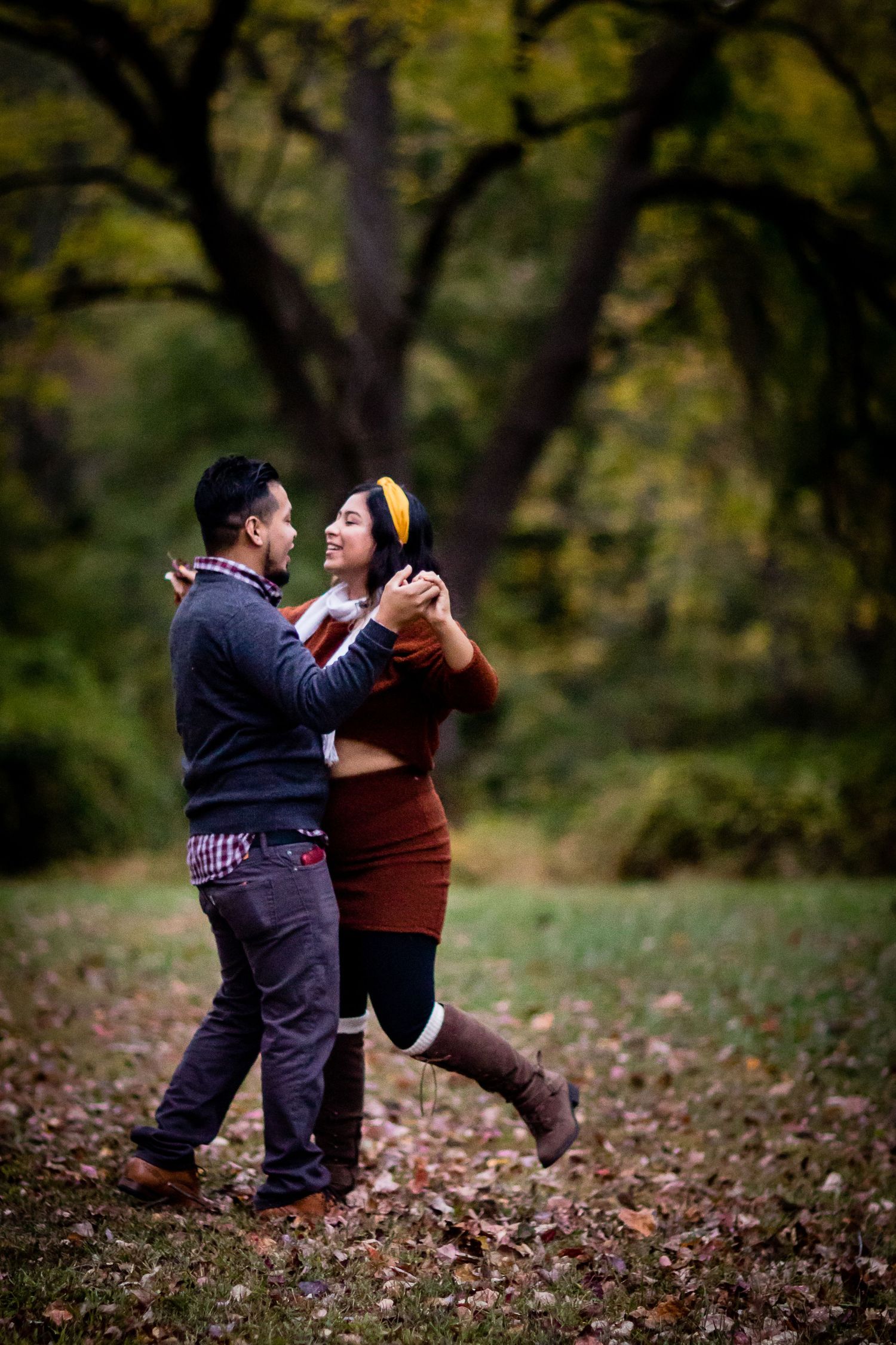 A couple dances together in a romantic autumn forest setting at Gambrill State Park in Frderick, MD