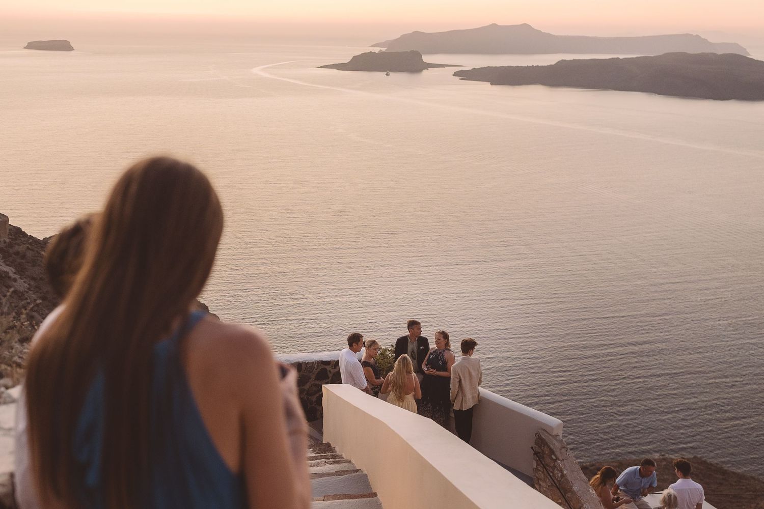 Santorini Wedding guests enjoying a beautiful sunset over the Megalachori Calderea at El Viento.