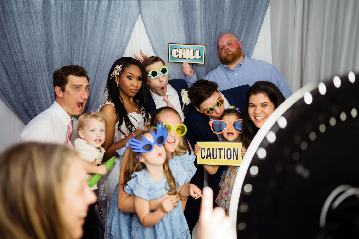 A series of wedding reception photos showing guests dancing and celebrating at a party with dark lighting and decor.