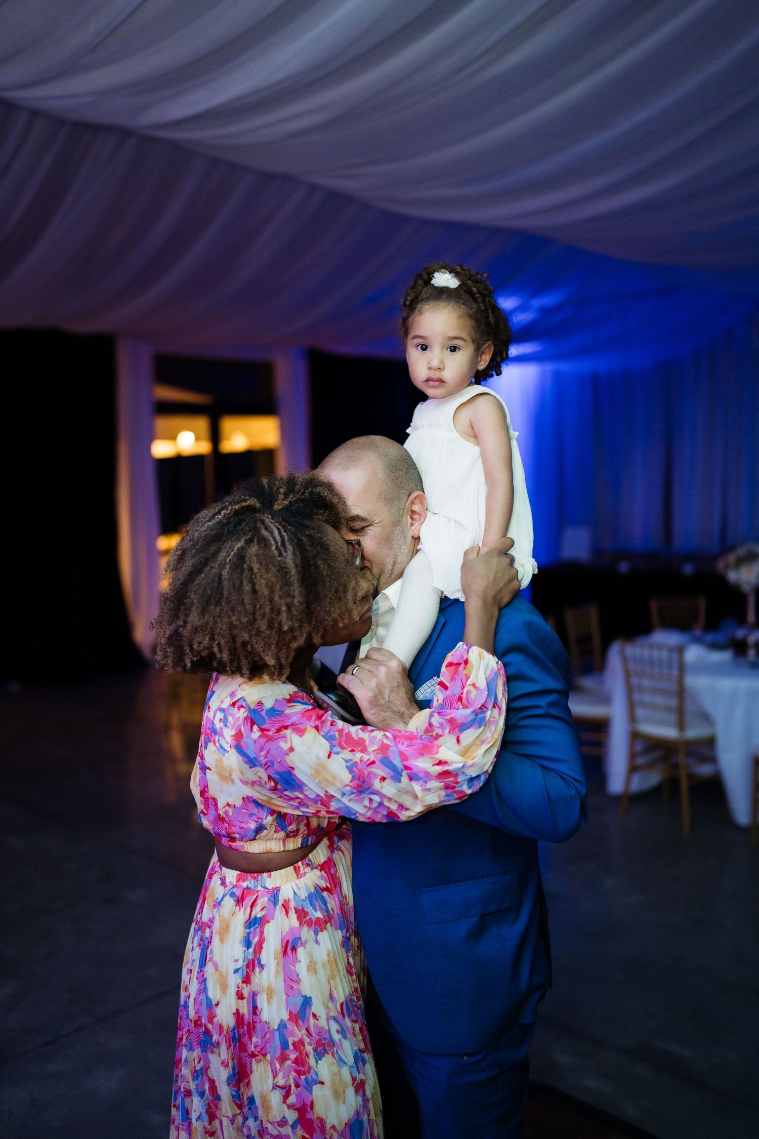 A sequence of dance photos showing a couple in formal attire with blue lighting at an indoor event.