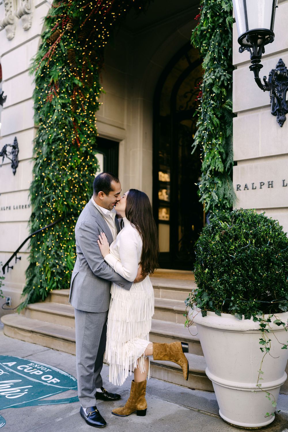 A romantic moment captured in a series of photos showing a couple embracing outside an elegant building with ivy and flowers.