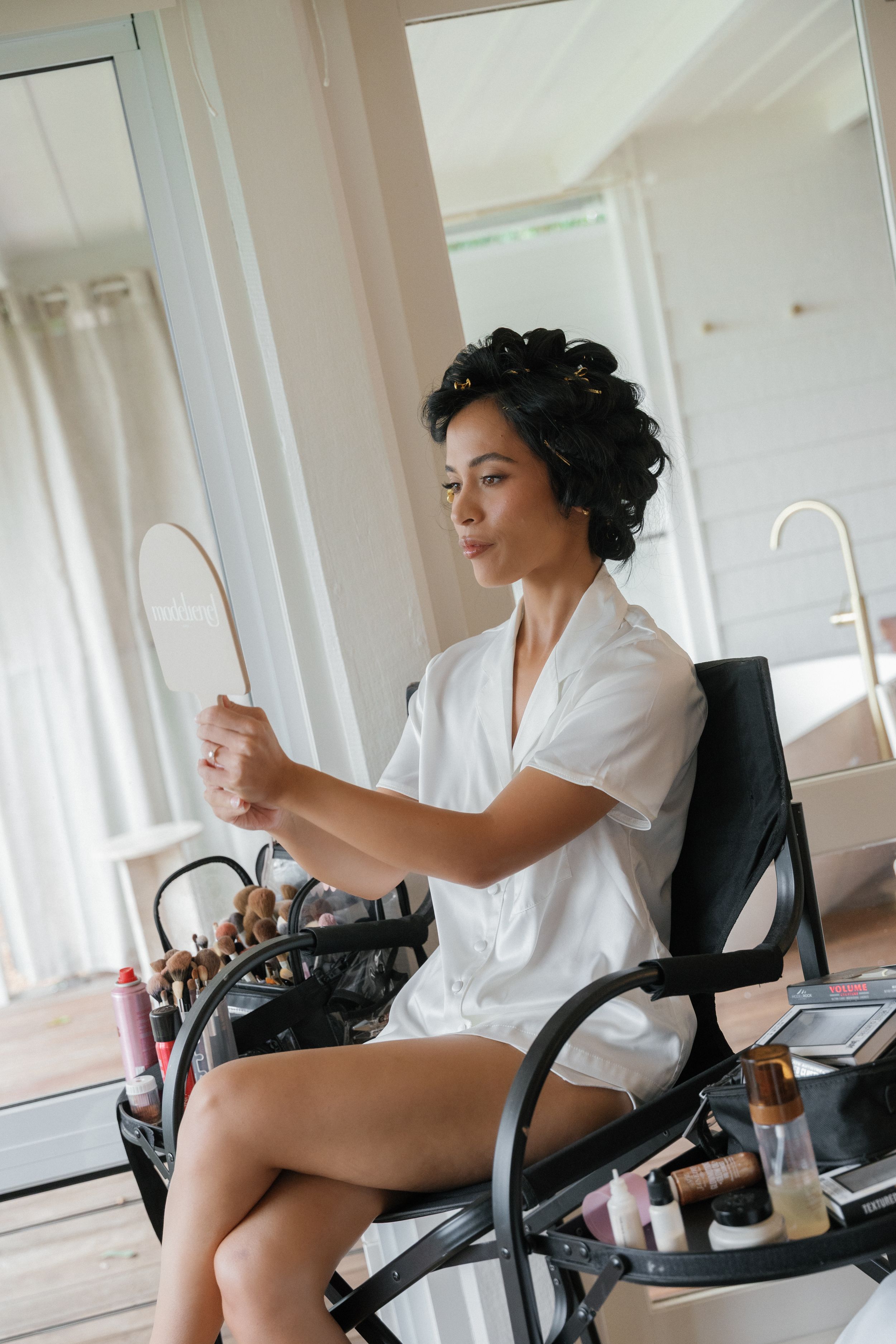 A person in a white shirt sits in an office chair in multiple poses during a photoshoot.