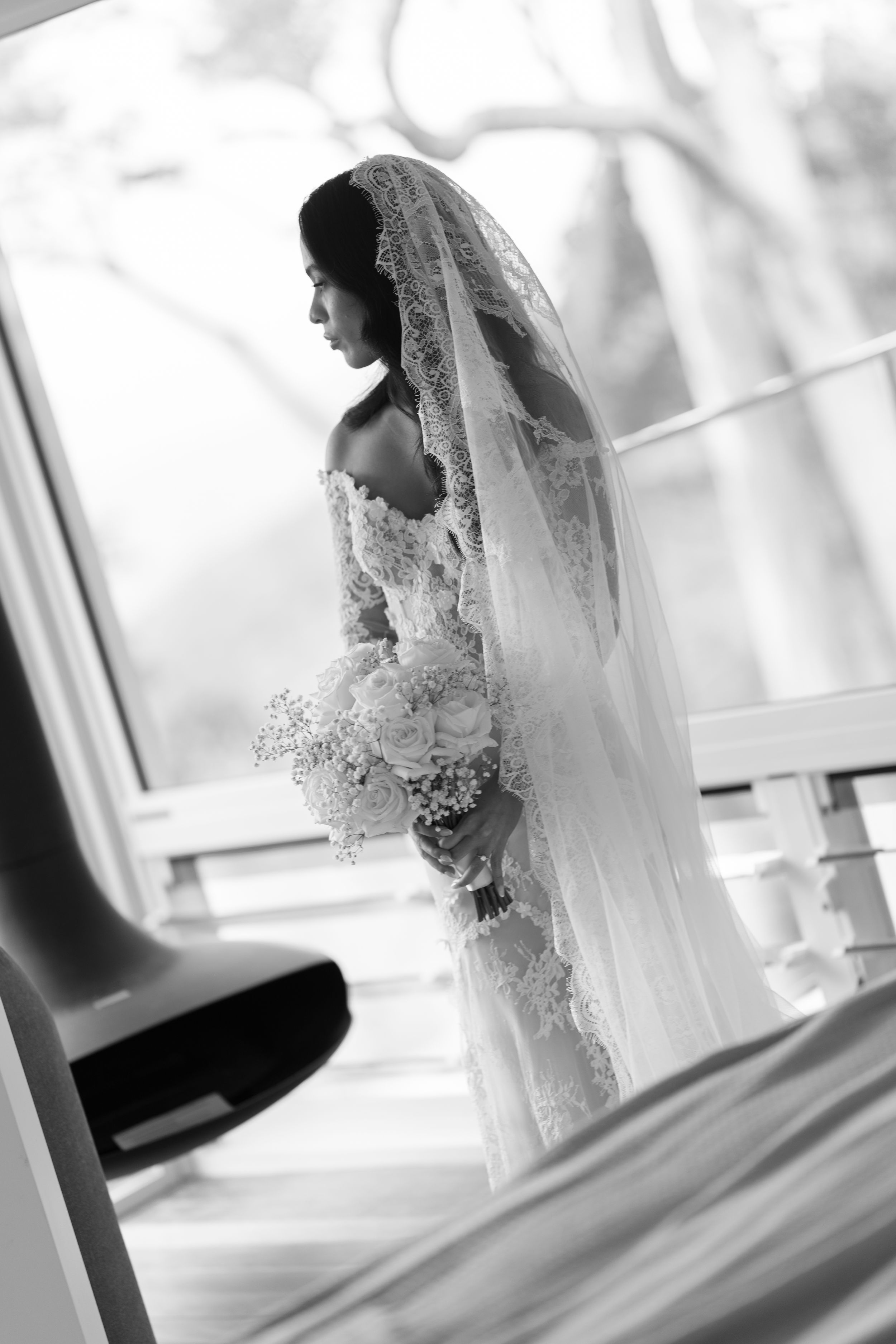 A black and white collage of a bride in a lace wedding dress with flowing veil captured from different angles.