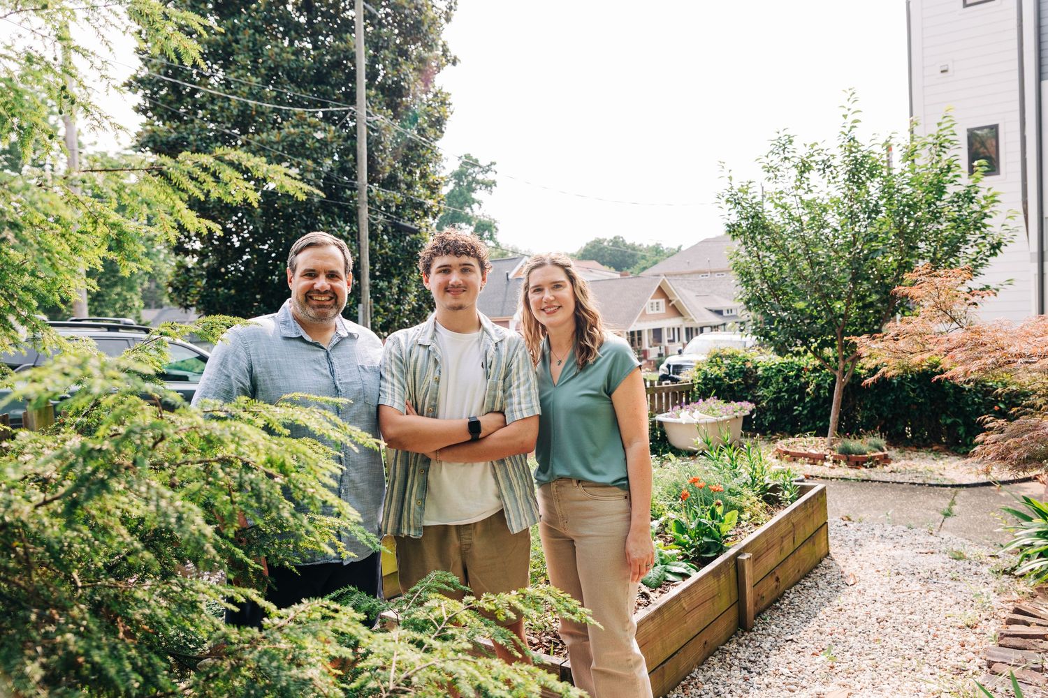 A family smiles together in their Charlotte garden.