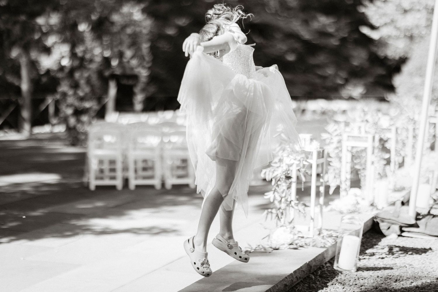 A black and white photo montage of an outdoor wedding ceremony with chairs and decorations set up in a garden setting.