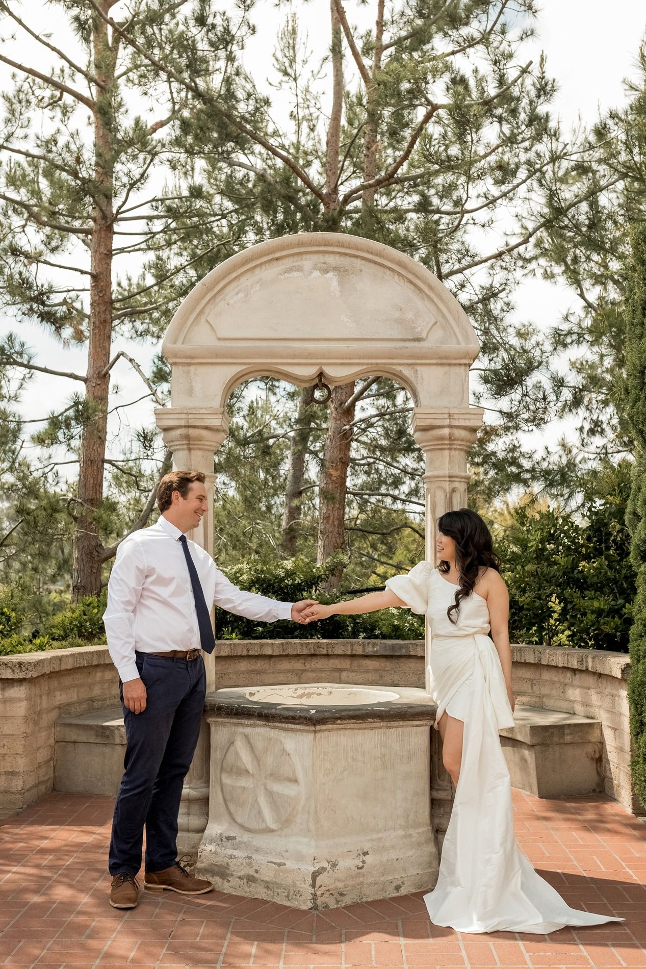 A romantic sequence of wedding photos showing a couple playfully interacting on a stone terrace surrounded by pine trees at Balboa Park.
