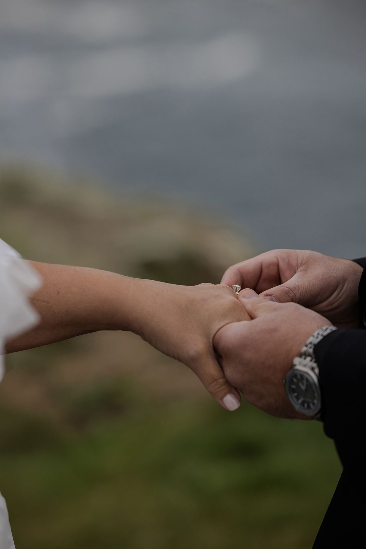 Bride and groom reading vows at Hags Head overlooking the Atlantic Ocean