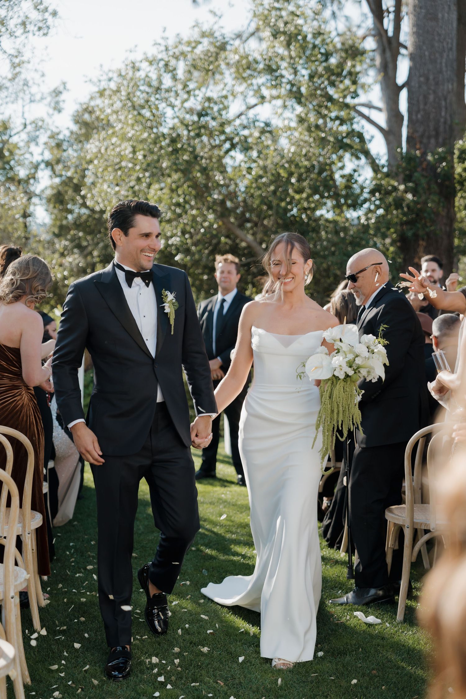 Candid couple walking hand-in-hand at La Playa in Carmel California