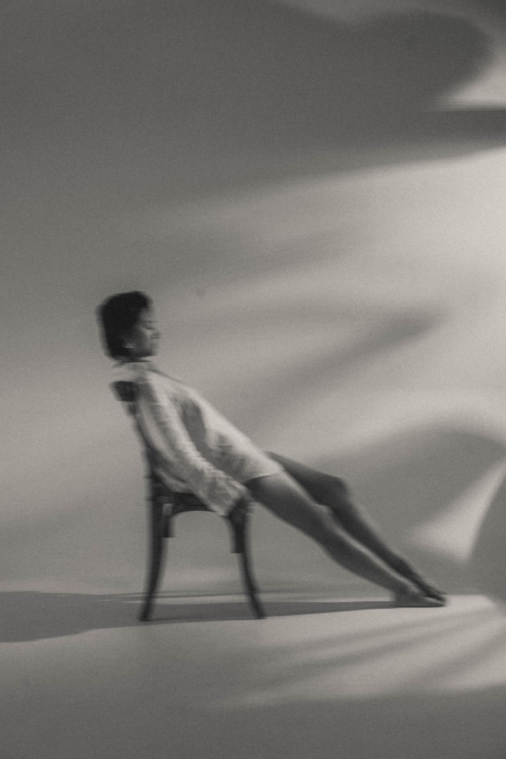 Artistic black and white sequence showing fluid movement across a light background.
