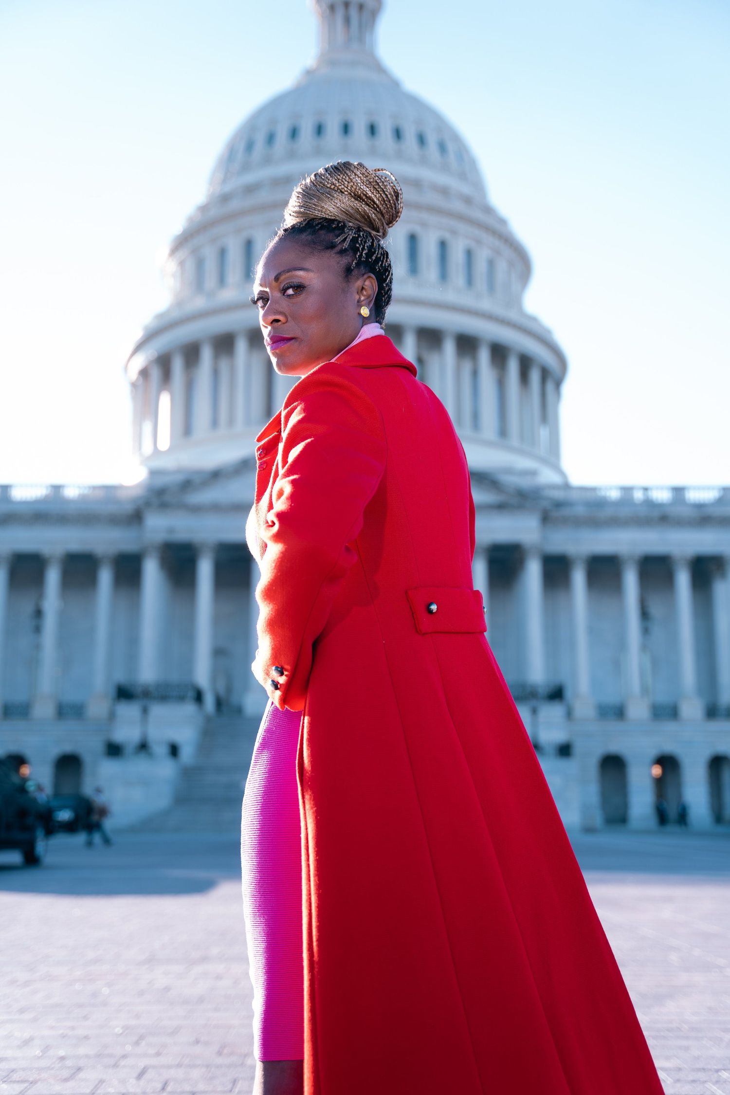 A striking red coat stands out against the backdrop of the US Capitol building in Washington DC.