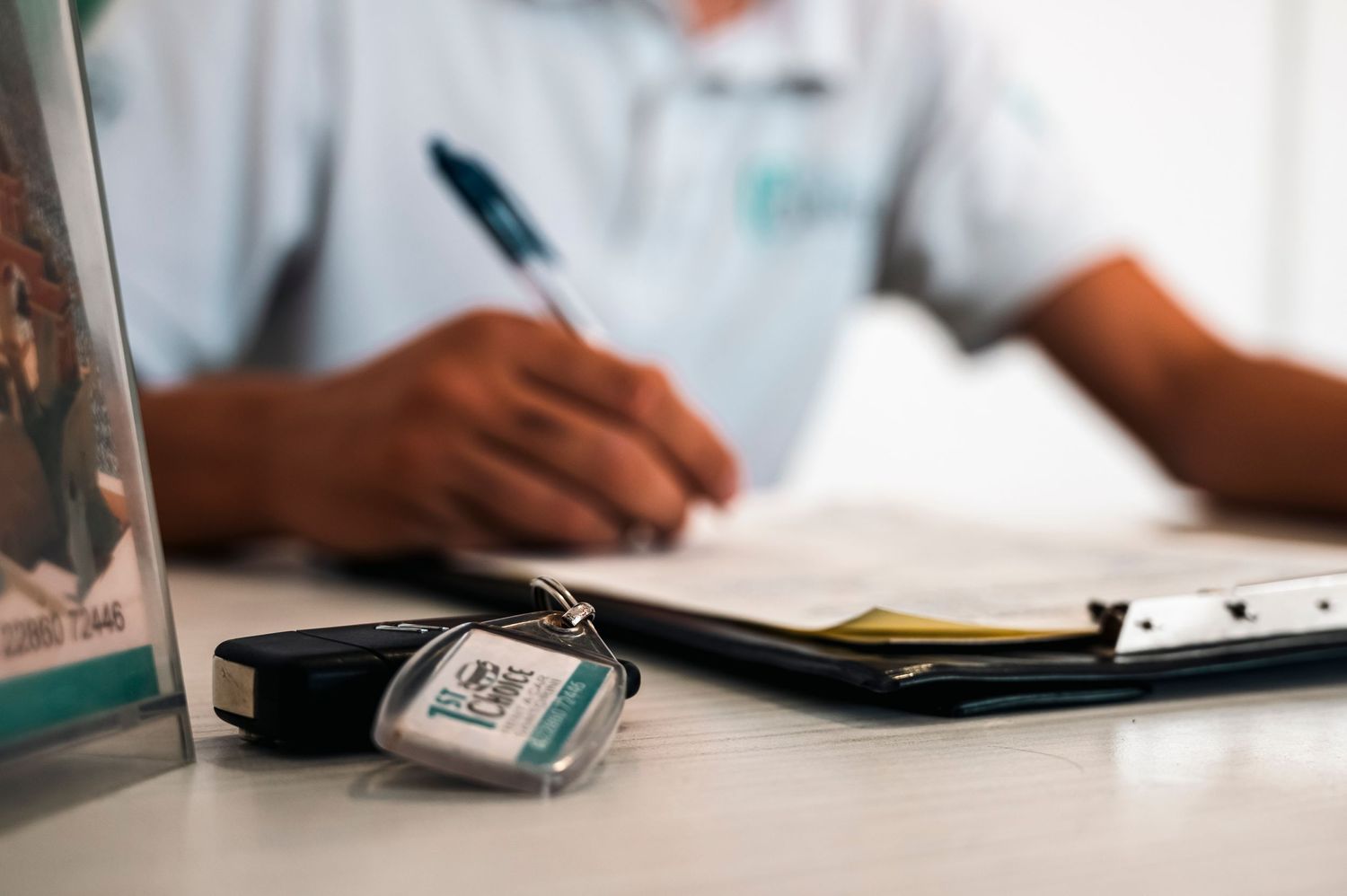 Desktop scene showing paperwork and digital blood pressure monitor in medical setting.