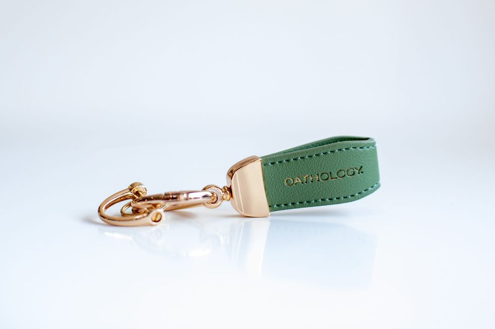 Oathology key chain product photo in Cincinnati studio with professional branding photography for business marketing.