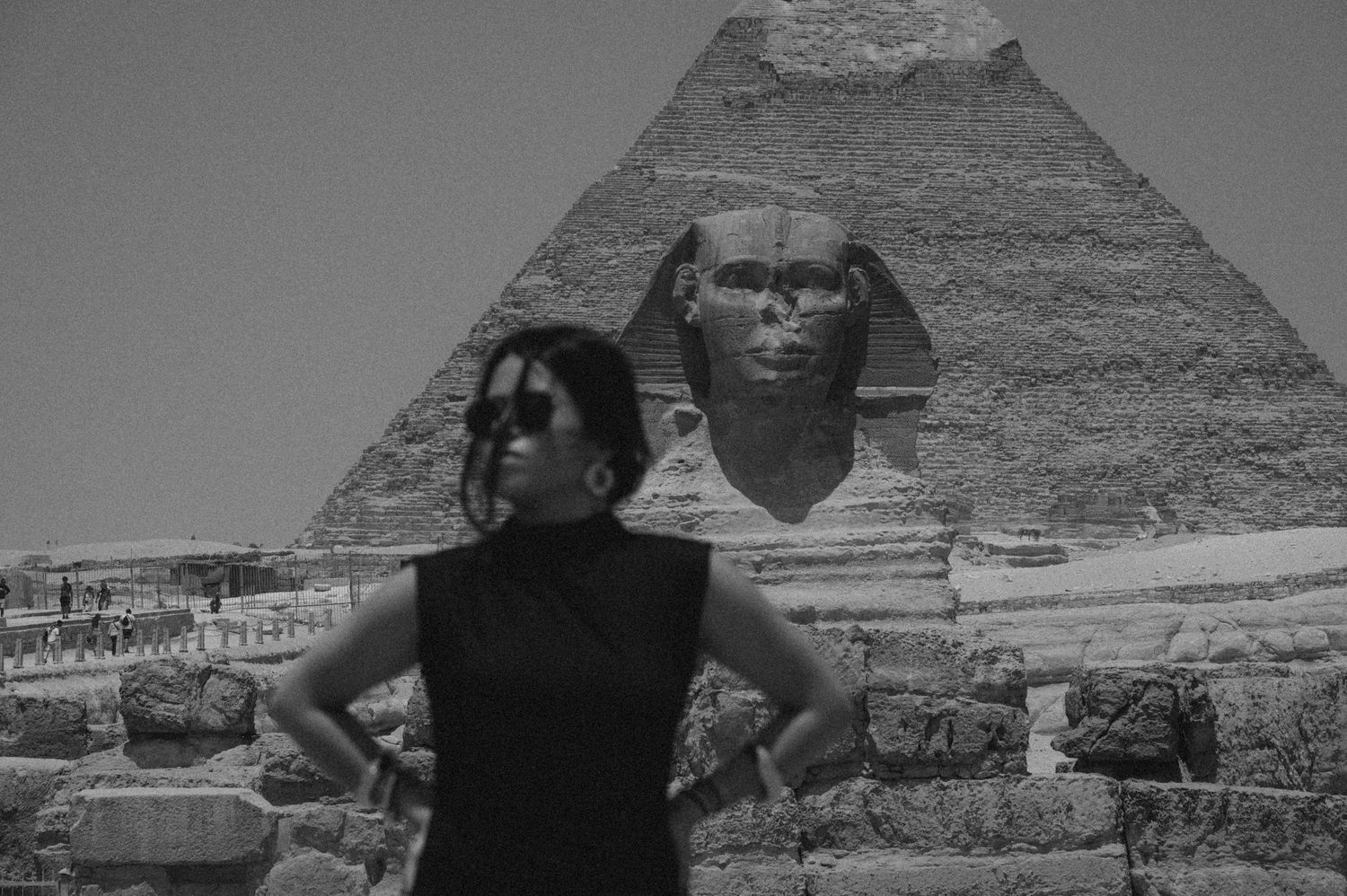 A series of black and white photographs showing the Great Pyramids and Sphinx of Giza in Egypt against a cloudy sky.